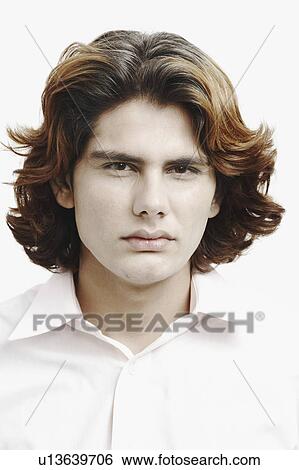 Stock Photograph - Portrait of a young man looking serious. Fotosearch
