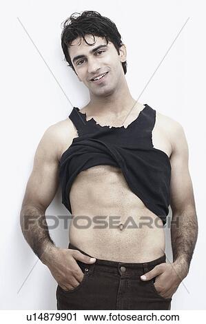 Portrait of a young man showing his abdomen View Large Photo Image Stock Image - Portrait of a young man showing his abdomen. Fotosearch