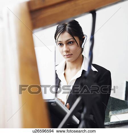 Picture - Businesswoman using a laptop. Fotosearch
