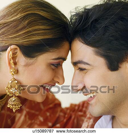 Close-up of a young couple smiling View Large Photo Image Stock Photo - Close-up of a young couple smiling. Fotosearch