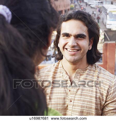 Close-up of a young couple standing face to face View Large Photo Image Stock Image - Close-up of a young couple standing face to face. Fotosearch
