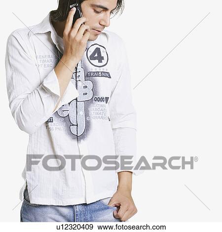 Close-up of a young man talking on a mobile phone View Large Photo Image Stock Photo - Close-up of a young man talking on a mobile phone. Fotosearch