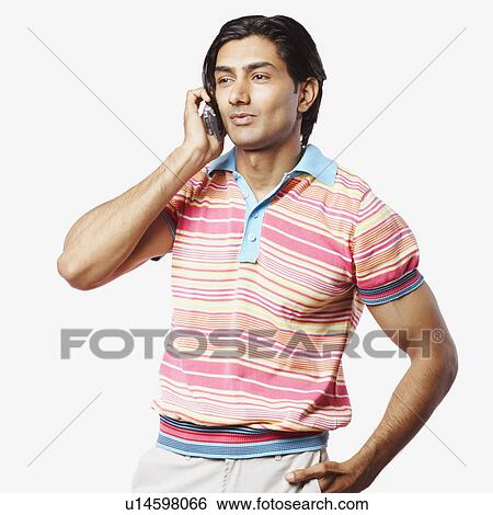 Close-up of a young man talking on a mobile phone View Large Photo Image Stock Photograph - Close-up of a young man talking on a mobile phone. Fotosearch