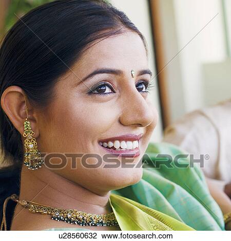 Close-up of a young woman smiling View Large Photo Image Stock Image - Close-up of a young woman smiling. Fotosearch
