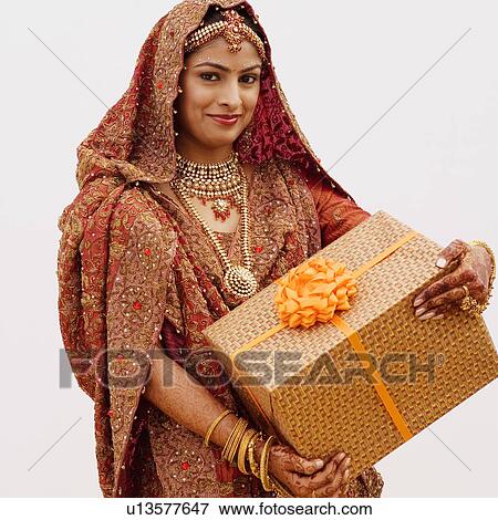 Stock Photo - Portrait of a bride holding a gift. Fotosearch