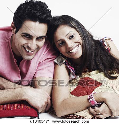 Portrait of a young couple lying on the floor and smiling View Large Photo Image Stock Image - Portrait of a young couple lying on the floor and smiling. Fotosearch
