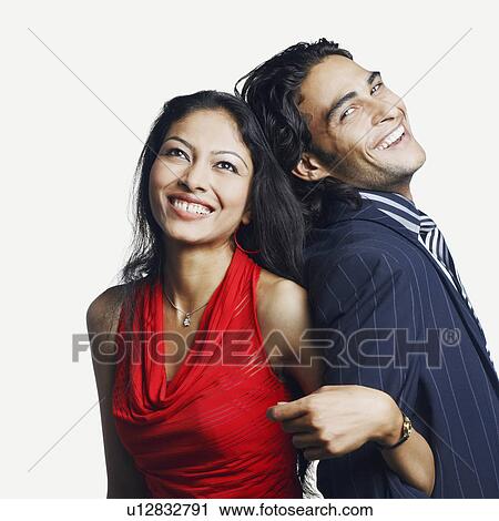 Stock Image - Portrait of a young man leaning against a young woman and smiling. Fotosearch