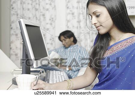 Close-up of a young woman writing with a pen View Large Photo Image Stock Image - Close-up of a young woman writing with a pen. Fotosearch