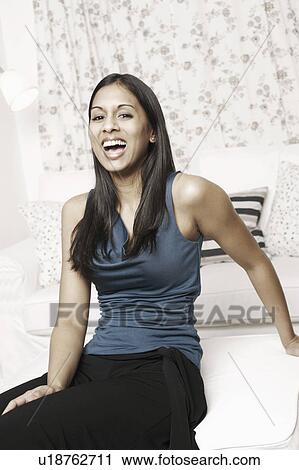 Portrait of a young woman laughing View Large Photo Image Stock Image - Portrait of a young woman laughing. Fotosearch