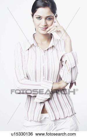 Stock Photograph - Portrait of a young woman with her head in her hands. Fotosearch
