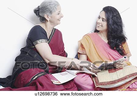 Side profile of a mother and her daughter talking View Large Photo Image Stock Photograph - Side profile of a mother and her daughter talking. Fotosearch