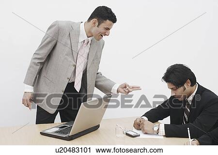 Stock Image - Businessman shouting at another businessman. Fotosearch