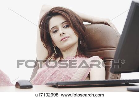 Stock Photo - Businesswoman sitting in front of a computer. Fotosearch