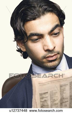 Close-up of a businessman reading a newspaper View Large Photo Image Stock Photo - Close-up of a businessman reading a newspaper. Fotosearch