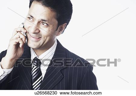 Stock Image - Close-up of a businessman talking on a mobile phone. Fotosearch