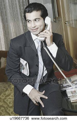 Close-up of a businessman talking on the telephone View Large Photo Image Stock Photograph - Close-up of a businessman talking on the telephone. Fotosearch