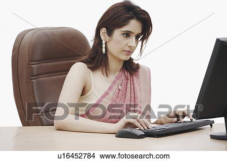 Close-up of a businesswoman working on a computer View Large Photo Image Picture - Close-up of a businesswoman working on a computer. Fotosearch