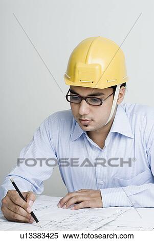 Close-up of an architect drawing a blueprint View Large Photo Image Stock Photography - Close-up of an architect drawing a blueprint. Fotosearch
