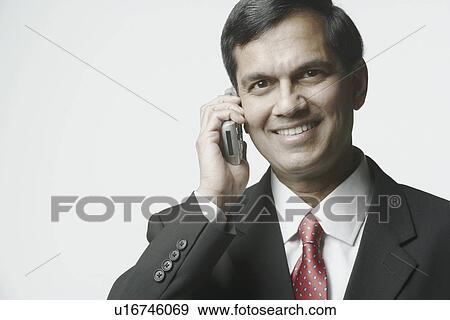 Portrait of a businessman talking on a mobile phone View Large Photo Image Stock Photo - Portrait of a businessman talking on a mobile phone. Fotosearch