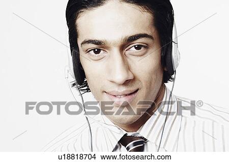 Picture - Portrait of a businessman wearing a headset. Fotosearch