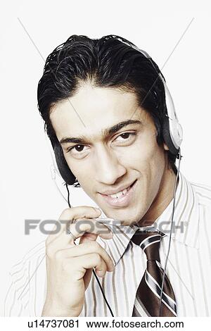 Portrait of a businessman wearing a headset View Large Photo Image Stock Image - Portrait of a businessman wearing a headset. Fotosearch