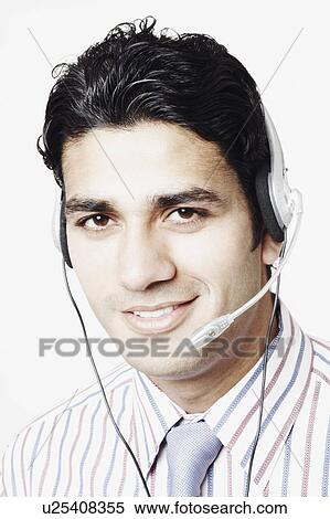 Stock Photography - Portrait of a businessman wearing headphones. Fotosearch