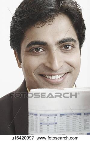 Stock Photo - Portrait of a businessman with a newspaper in front of him. Fotosearch