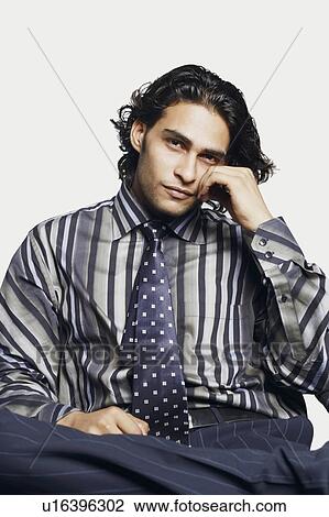 Portrait of a businessman with his hand on his cheek View Large Photo Image Stock Image - Portrait of a businessman with his hand on his cheek. Fotosearch