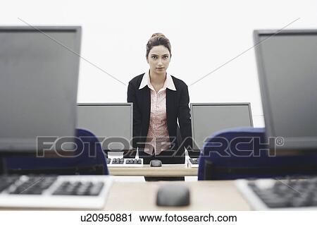 Portrait of a businesswoman leaning against the table View Large Photo Image Stock Image - Portrait of a businesswoman leaning against the table. Fotosearch