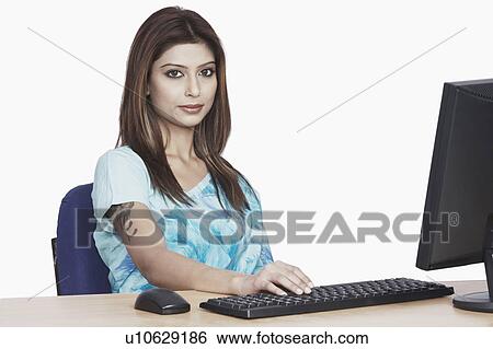 Portrait of a businesswoman sitting in front of a computer View Large Photo Image Stock Photograph - Portrait of a businesswoman sitting in front of a computer. Fotosearch