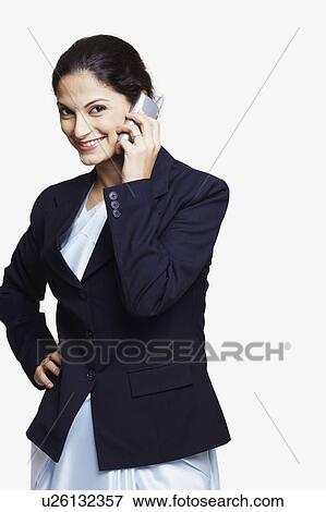 Portrait of a businesswoman talking on a mobile phone and smiling View Large Photo Image Stock Photo - Portrait of a businesswoman talking on a mobile phone and smiling. Fotosearch