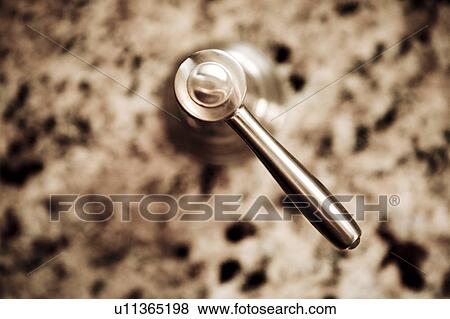 Stock Photo - Chrome Sink Knob and Granite Counter. Fotosearch
