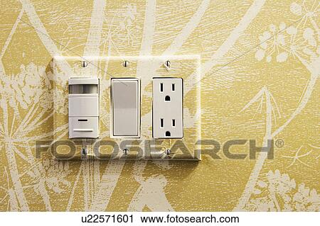 Stock Image - Contemporary Yellow Wallpaper and Lightswitch/Outlet. Fotosearch