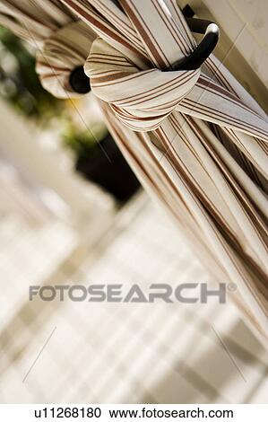 Stock Image - Outdoor Drapery on Traditional Back Porch. Fotosearch