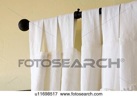 White curtains hanging from black curtain rod View Large Photo Image Stock Photo - White curtains hanging from black curtain rod. Fotosearch