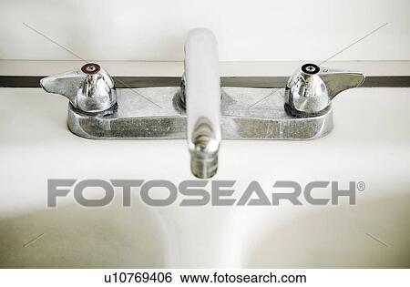 Stock Photograph - White Sink and Chrome Faucet. Fotosearch
