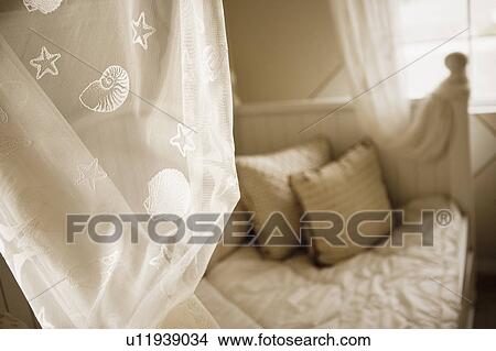 Bed with shell patterned drapery View Large Photo Image Picture - Bed with shell patterned drapery. Fotosearch