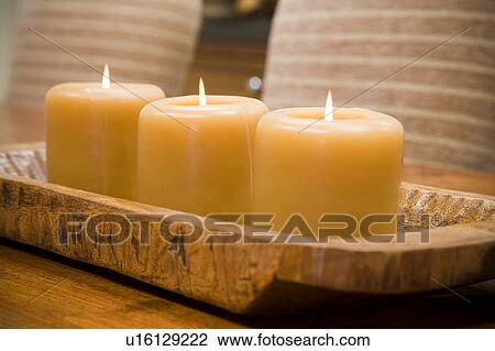 Detail of three lit candles on wooden holder. View Large Photo Image Stock Image - Detail of three lit candles on wooden holder.. Fotosearch