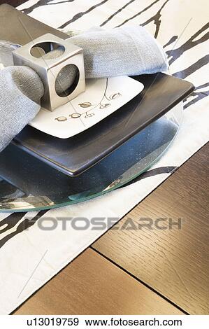 Place setting with plates and napkin with napkin ring (close up) View Large Photo Image Stock Photo - Place setting with plates and napkin with napkin ring (close up). Fotosearch
