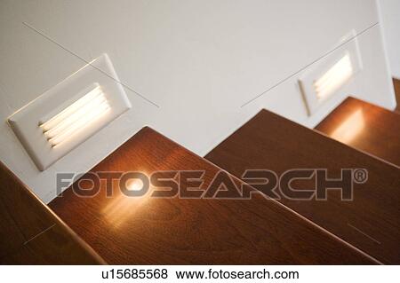 Stock Photo - Detail of illuminated wooden steps.. Fotosearch