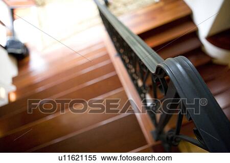 Stock Photography - High perspective of staircase with wrought iron handrail. Fotosearch