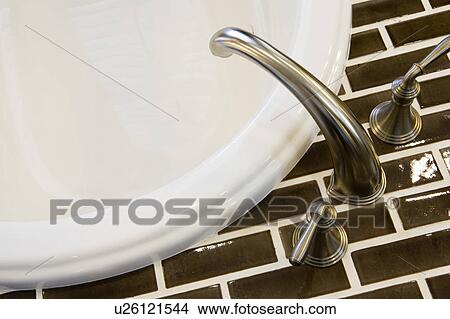 Detail of chrome faucet and brown tile. View Large Photo Image Picture - Detail of chrome faucet and brown tile.. Fotosearch