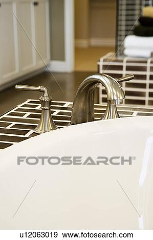 Stock Photo - Detail of faucet and sink. Fotosearch