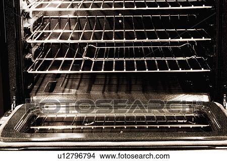 Picture - Inside of Clean Oven with Light On. Fotosearch