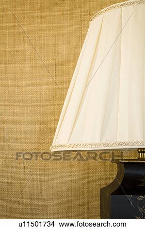 Picture - Lampshade against textured wall. Fotosearch
