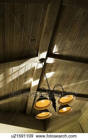 Stock Photo - Light Fixture and Vaulted Wood Beam Ceiling. Fotosearch