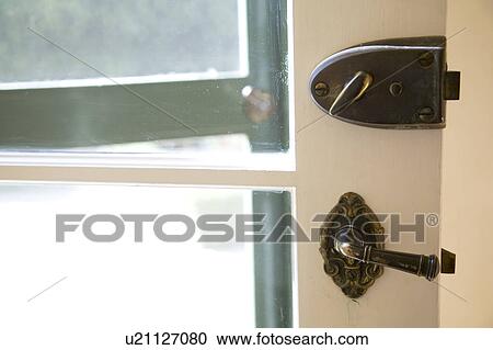 Stock Image - Lock and Handle on Front Door. Fotosearch