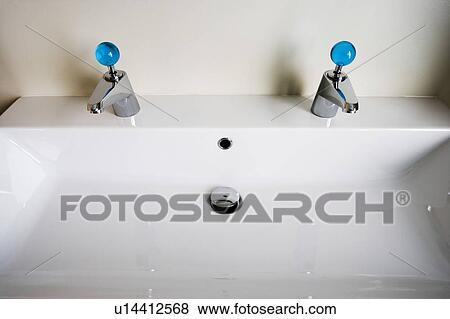 Modern White Sink with Blue Knobs View Large Photo Image Stock Photo - Modern White Sink with Blue Knobs. Fotosearch