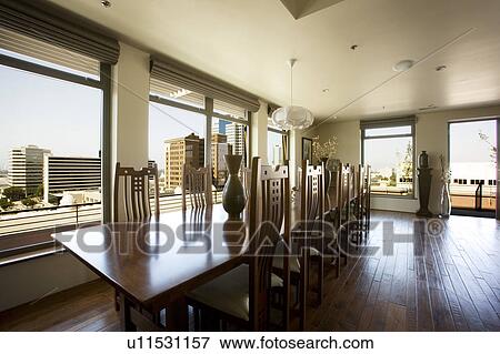 Stock Photo - Modern dining room table with view of city.. Fotosearch