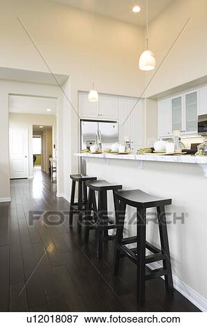 Three bar stool in a contemporary kitchen View Large Photo Image Stock Photo - Three bar stool in a contemporary kitchen. Fotosearch